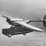 An image of a car in the sky with the body and wings of a plane mounted on top of it.