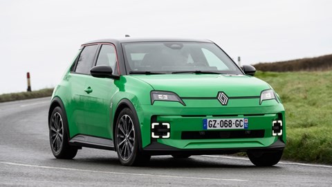 Renault 5 E-Tech in green driving around a corner