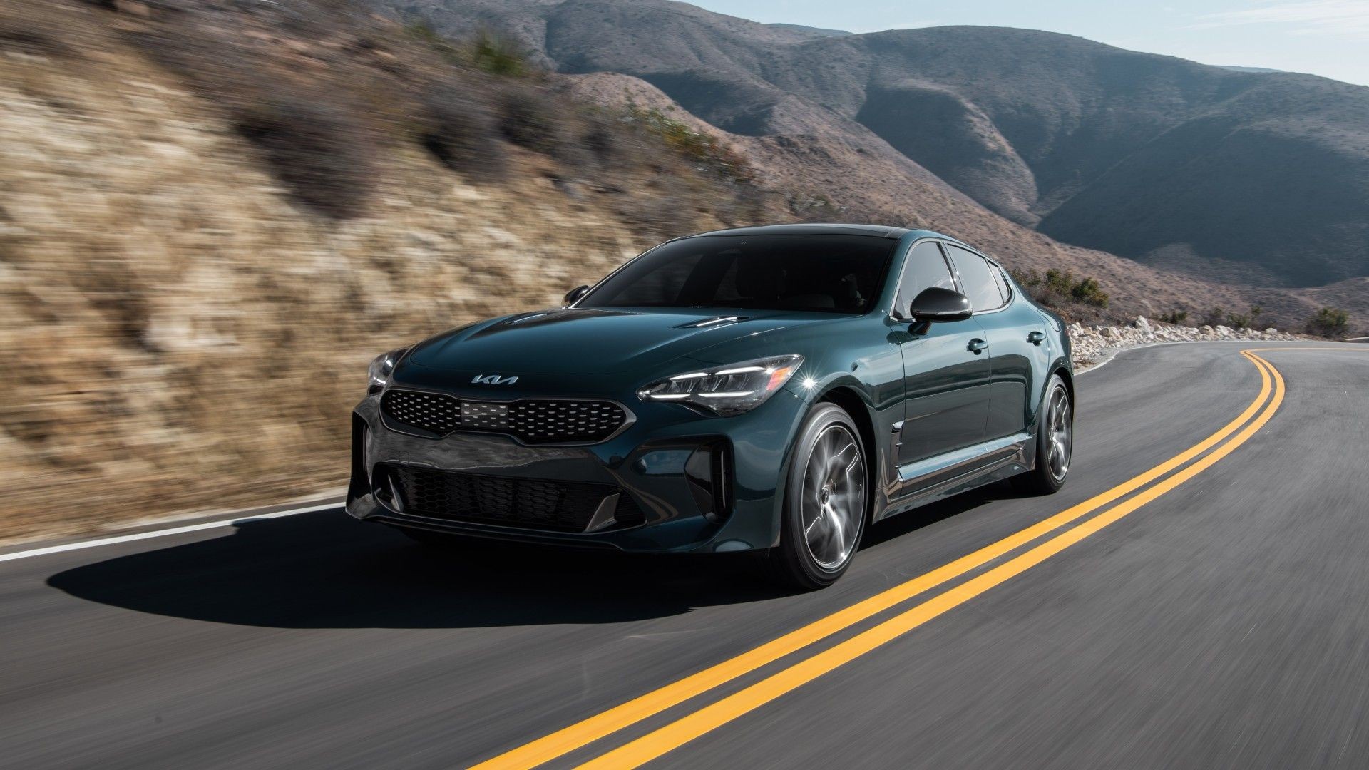 Front 3/4 shot of the 2023 Kia Stinger GT-Line cruising around a corner