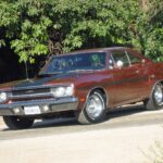 Front view of a burnt orange 1970 Plymouth GTX showcasing its clean lines and iconic muscle car design