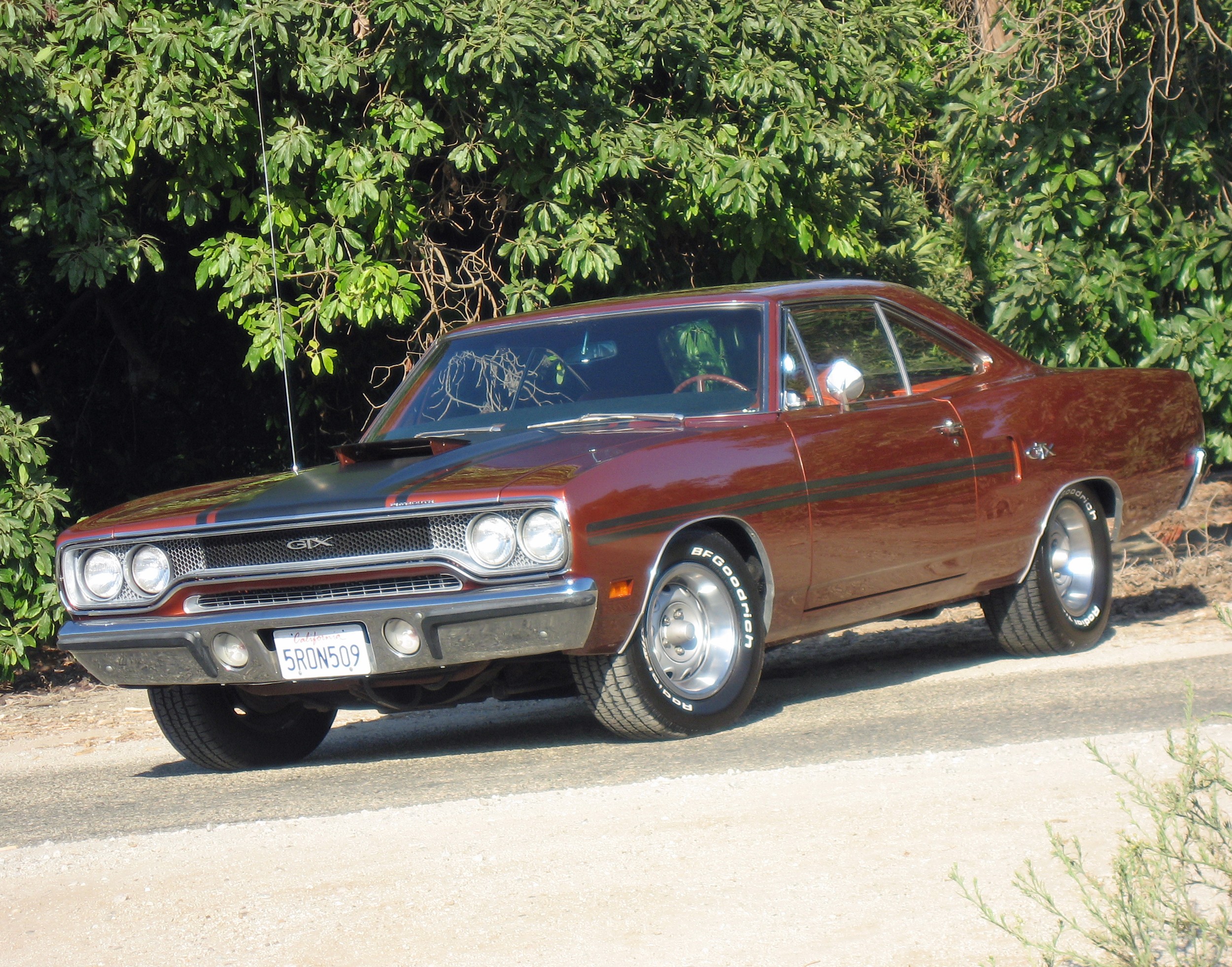 Front view of a burnt orange 1970 Plymouth GTX showcasing its clean lines and iconic muscle car design