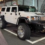 Front 3/4 view of a lifted white Hummer H2