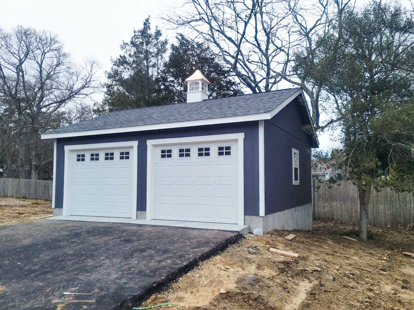 Blue 24x24 garage in Centerville, MA with cupola, illustrating a standard single-story two-car garage design