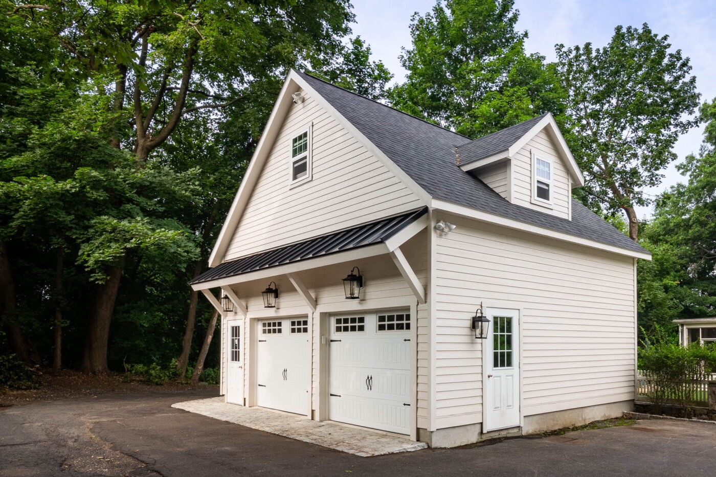 Creamy white 24x24 attic workshop 2-car garage with dormer and roof return in Greenwich, CT, showcasing enhanced vertical space