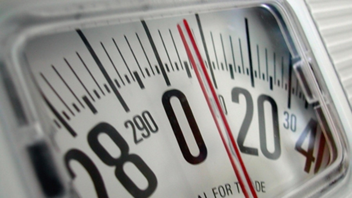 Woman Measuring Waist with Scale