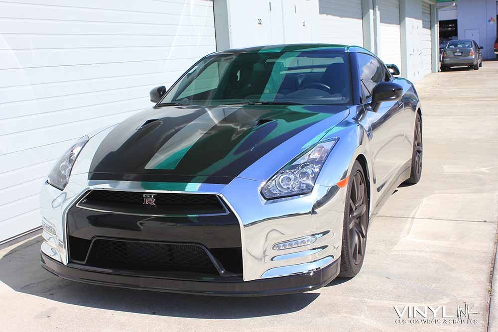 Nissan GTR with a striking chrome car wrap and black hood accents, demonstrating premium vinyl wrap finishes for vehicle customization.