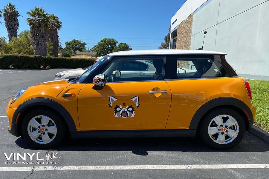 Close-up of a Mini Cooper featuring a custom partial car wrap decal, highlighting personalized vehicle restyling options.