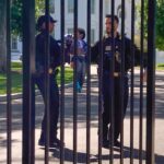 White House security fence with US Secret Service agents patrolling, illustrating general White House security measures, not directly related to the car crash incident.