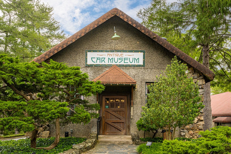 alt text: Exterior shot of Asheville car museum building with classic architectural details