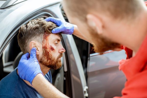 Woman holding her neck in pain after car accident