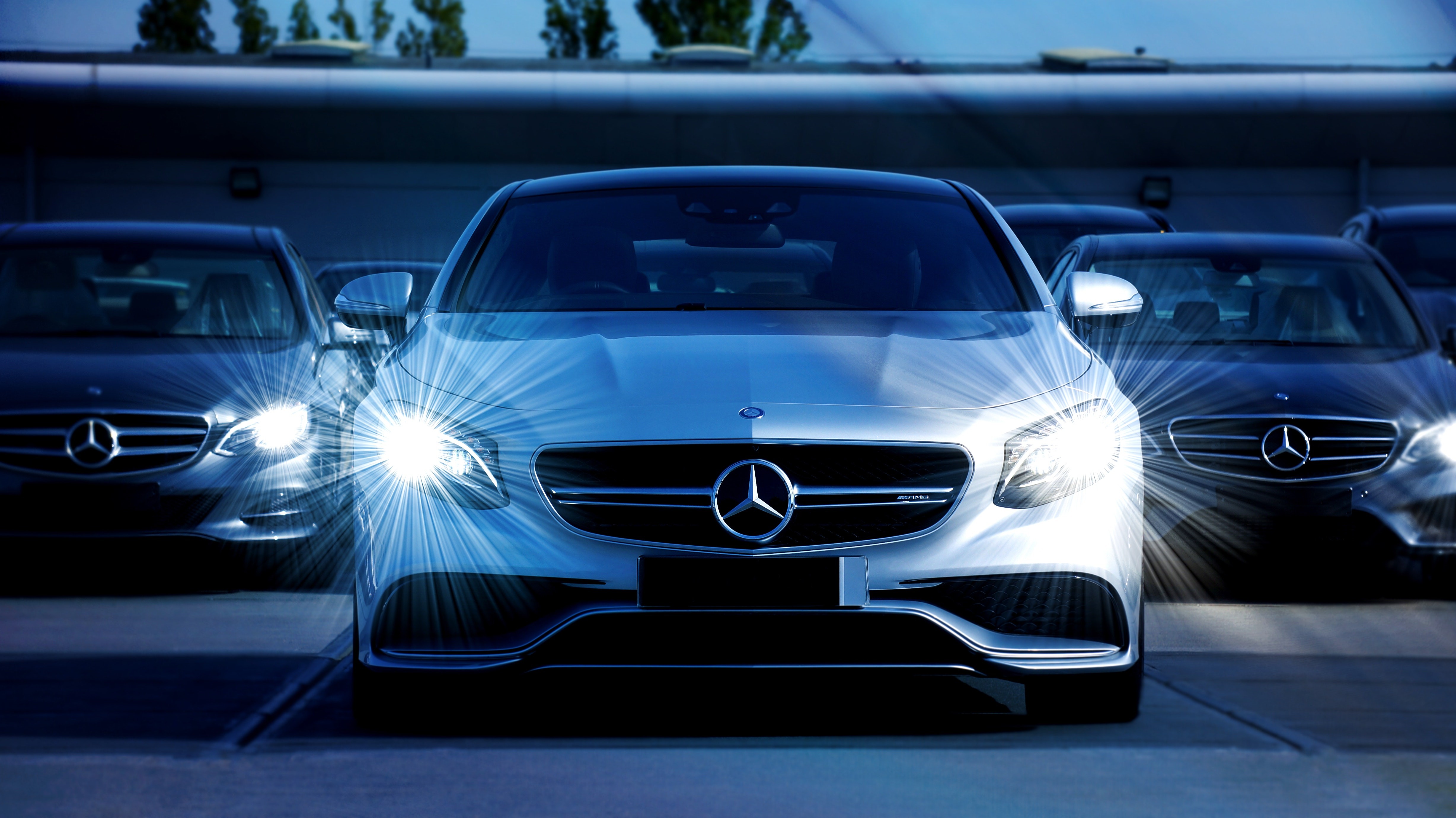 A lineup of luxury German car brands showcasing Mercedes-Benz, BMW, and Audi headlights, representing the excellence of German automotive engineering.