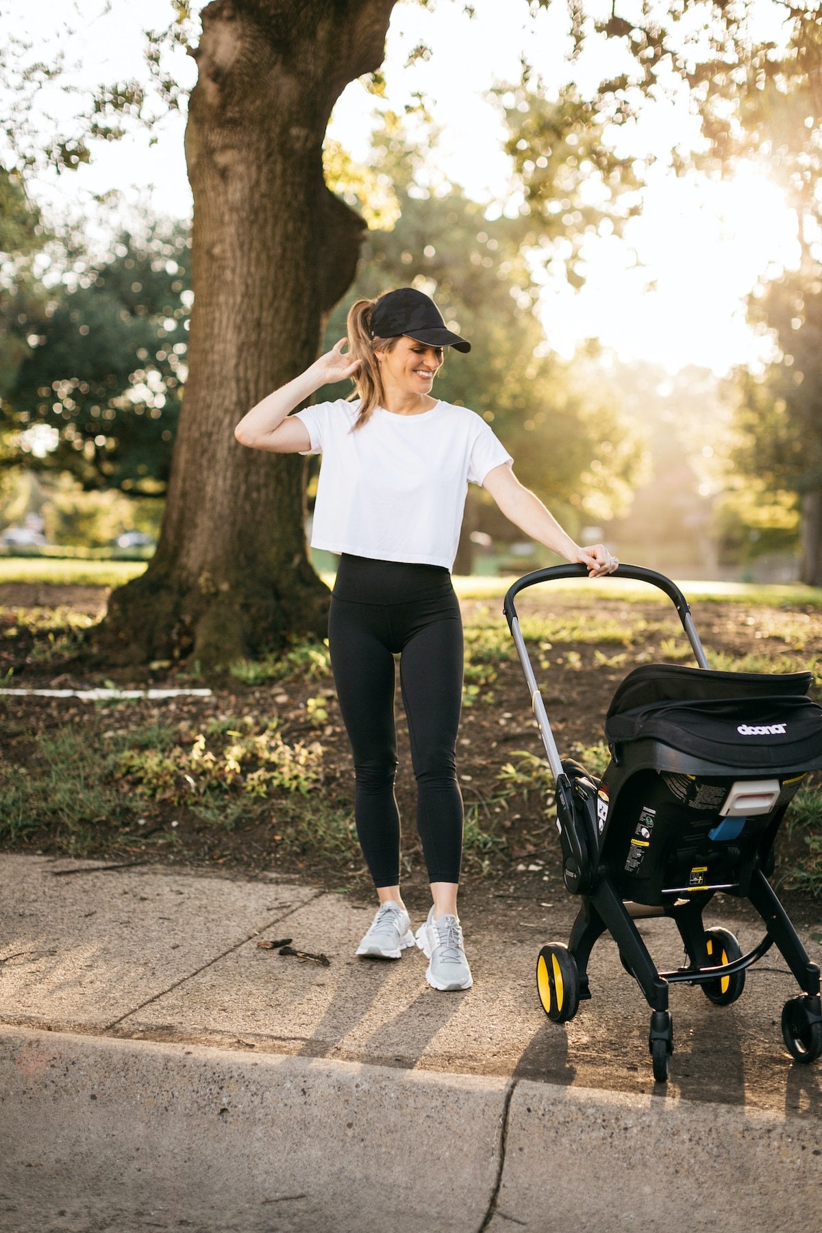 Woman using Doona stroller in an urban setting