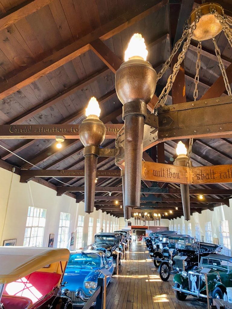 alt text: Roycroft chandelier inside the car museum in Asheville NC, showcasing intricate metalwork