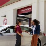 Woman talking with a Jiffy Lube technician about her car diagnostic test