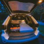 Car camping setup in a Jeep Grand Cherokee