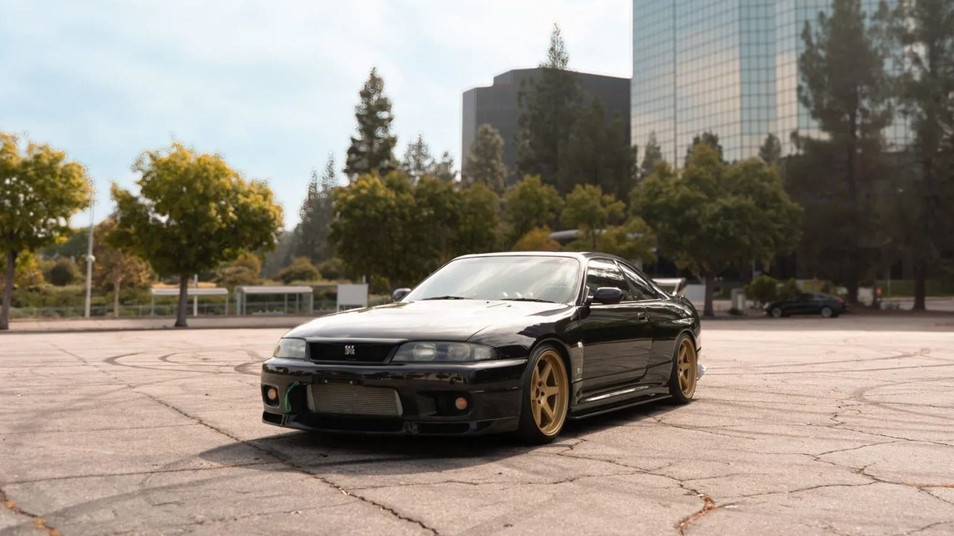 A black R33 Nissan GT-R basking in the sun. 