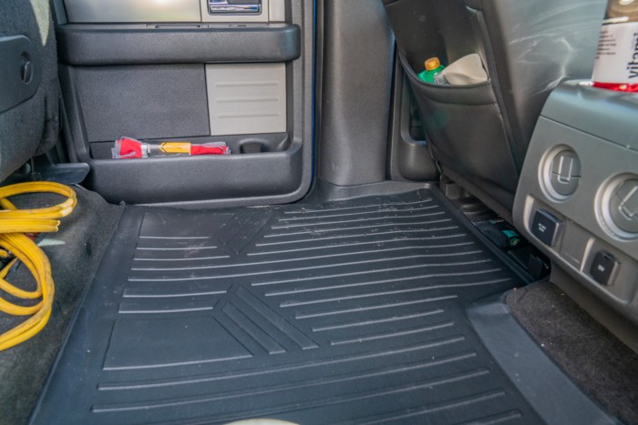 Backseat floor of a vehicle protected by a car floor mat