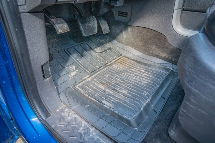 Car floor mat in the front footwell, showcasing tread design