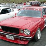 Shakotan style bosozoku car featuring lowered stance and extended exhaust pipes.