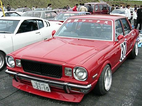 Shakotan style bosozoku car featuring lowered stance and extended exhaust pipes.