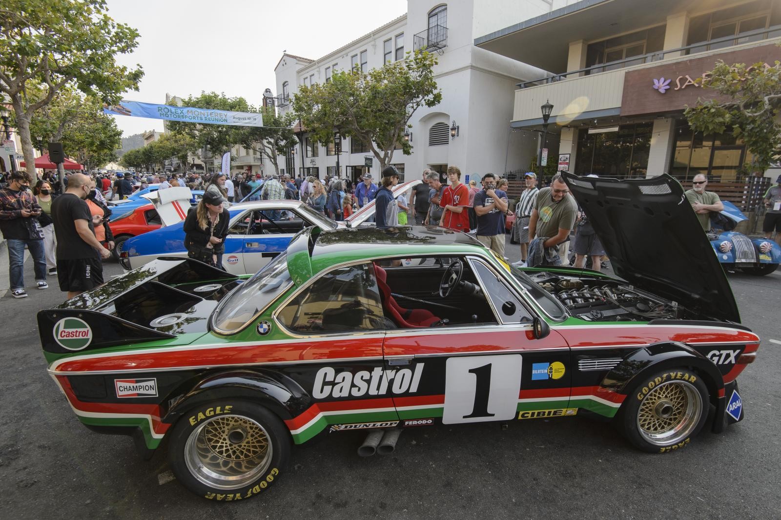 Historic race cars displayed on Alvarado Street in Monterey for Monterey Car Week Kickoff