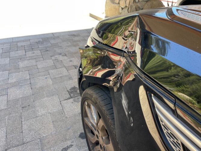 Damaged car in valet parking highlighting the benefit of owning a less expensive vehicle