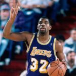 Magic Johnson in action for the Los Angeles Lakers, showcasing his dynamic point guard skills.