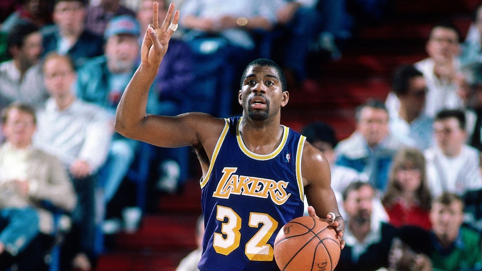 Magic Johnson in action for the Los Angeles Lakers, showcasing his dynamic point guard skills.