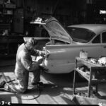 Vintage mechanic working on car.