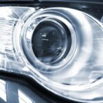 Close-up of a car headlight, illustrating available 0% car finance deals for new vehicles.