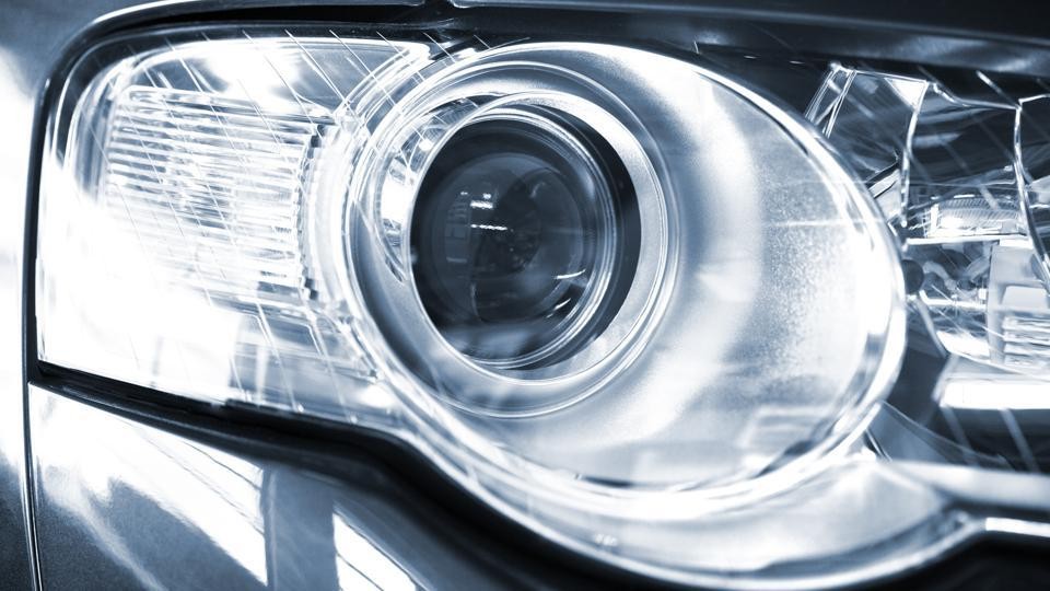 Close-up of a car headlight, illustrating available 0% car finance deals for new vehicles.