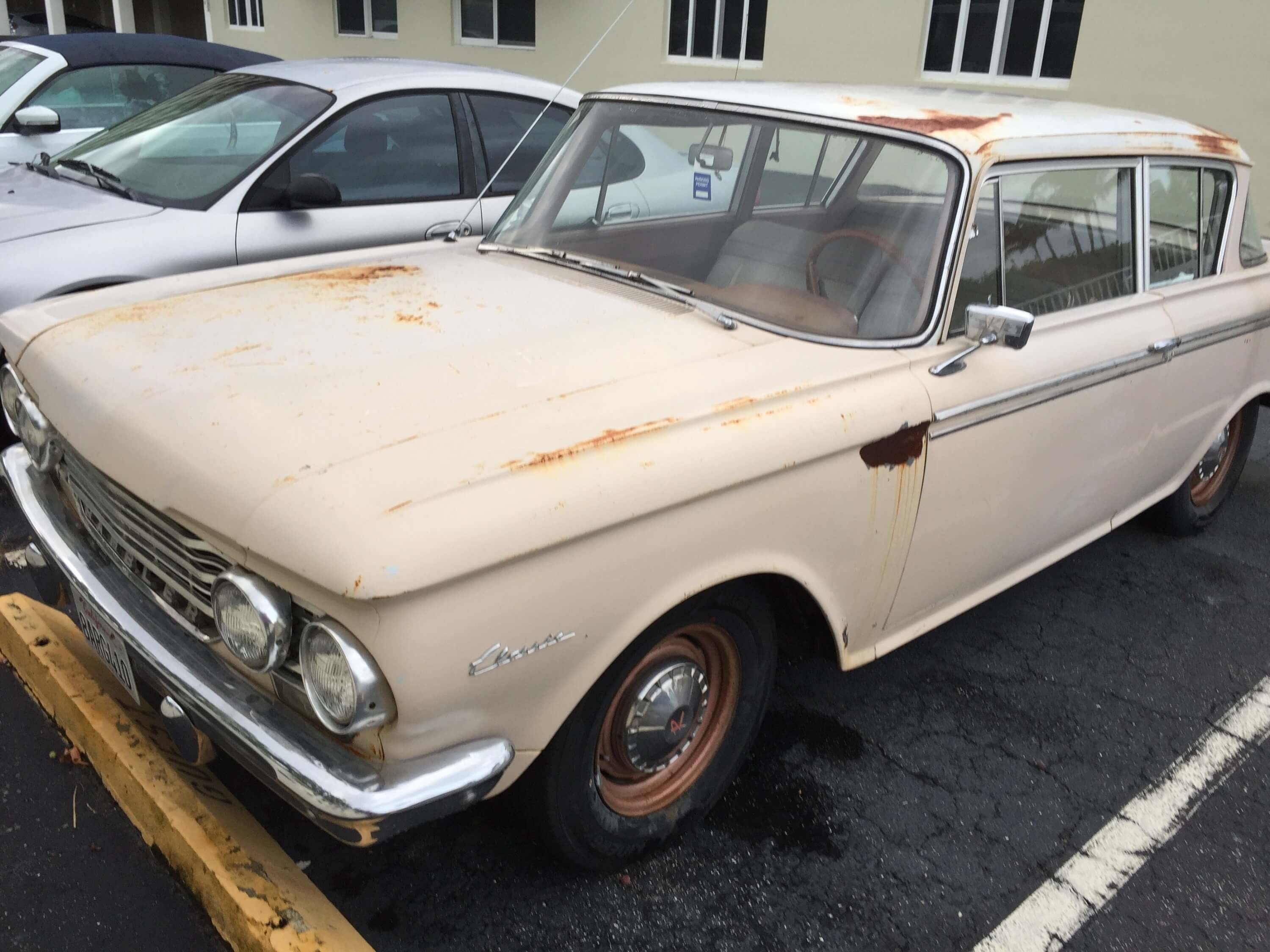 Classic Rambler car parked on a leafy street