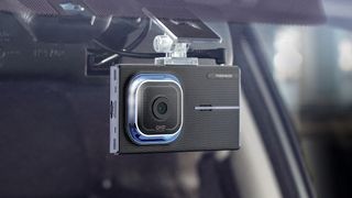 The Thinkware X1000 car dash camera mounted inside a car windshield