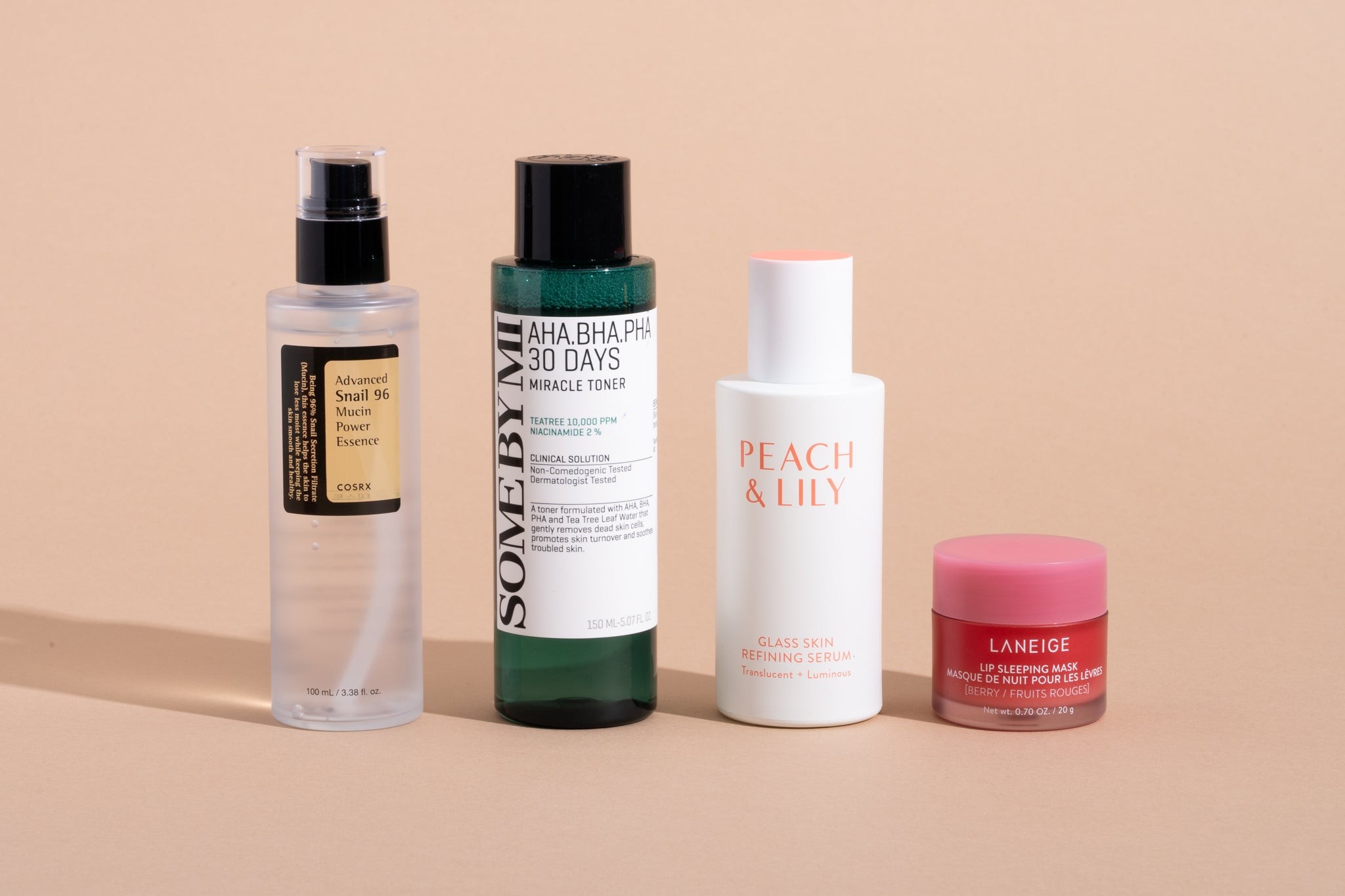 A curated selection of best Korean skin care products featuring snail mucin essence, glass skin serum, exfoliating toner, and lip sleeping mask.