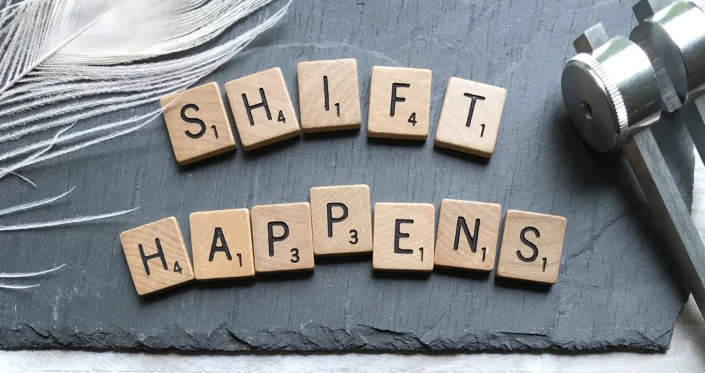 Scrabble tiles spelling out "Shift Happens" representing professional development goals.