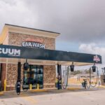 Exterior view of Super Duck Car Wash showing payment kiosks and entrance to the wash tunnel