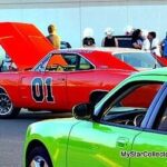 The General Lee, a 1969 Dodge Charger from The Dukes of Hazzard TV show, jumping over a dirt ramp, highlighting car stunts and potential damage